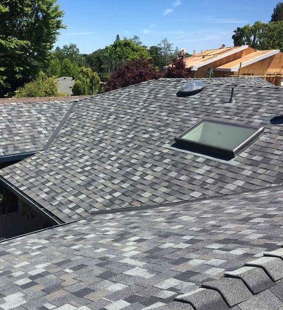 New roof installation in Palo Alto with slate grey composite tiles and a skylight