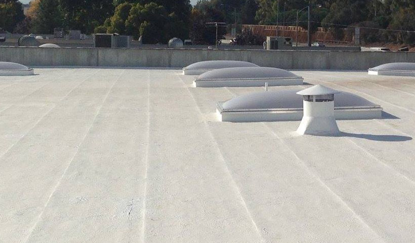 a flat, energy efficient roofing system installed on a shopping center near Santana Row